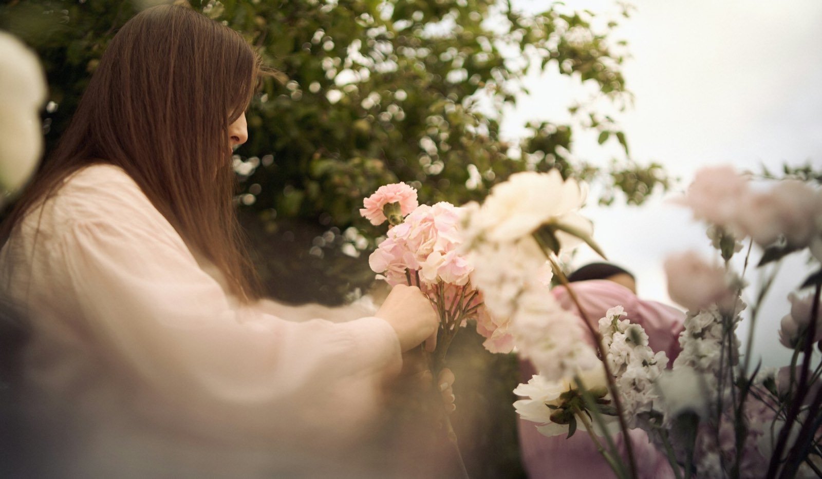 Florist arranging a pink bouquet